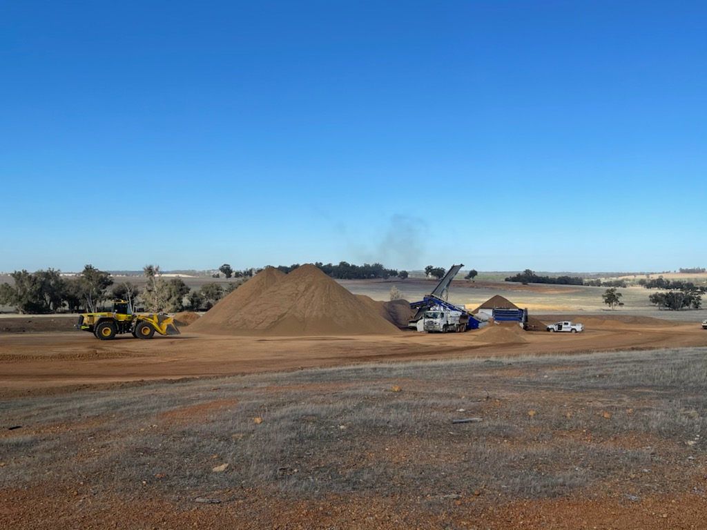 YongaCivil wheel loader, material stockpiles and screening plant on a rural Western Australian earthworks site