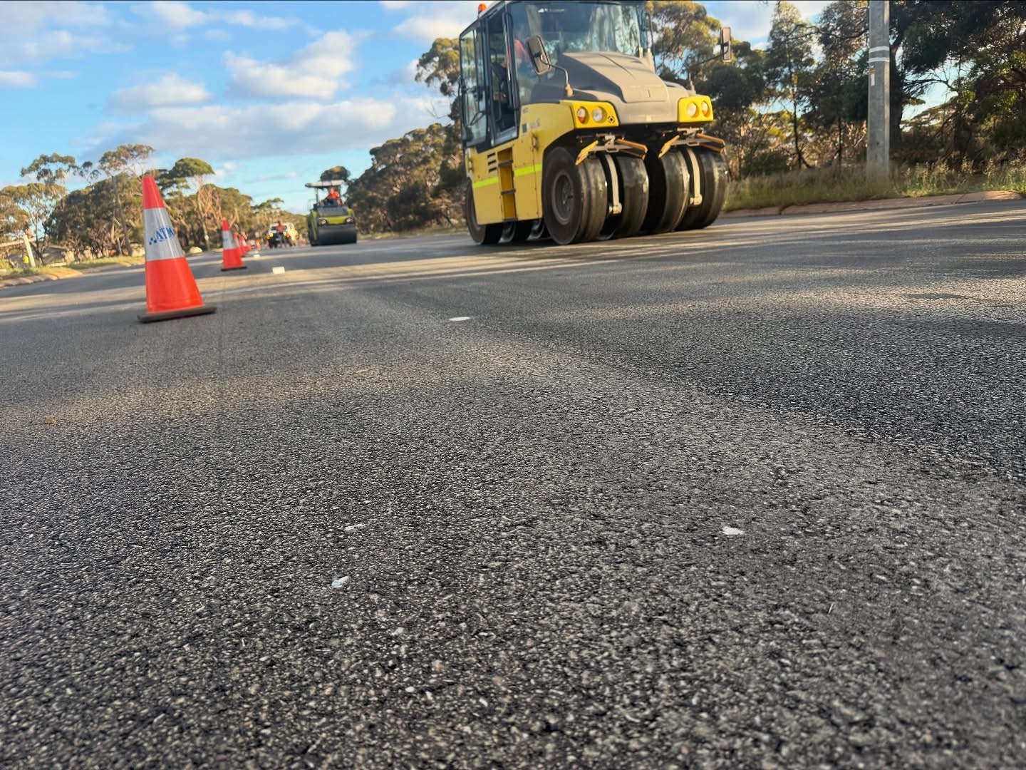 Multi-tyred pneumatic roller and support plant compacting a freshly sealed rural Western Australian road