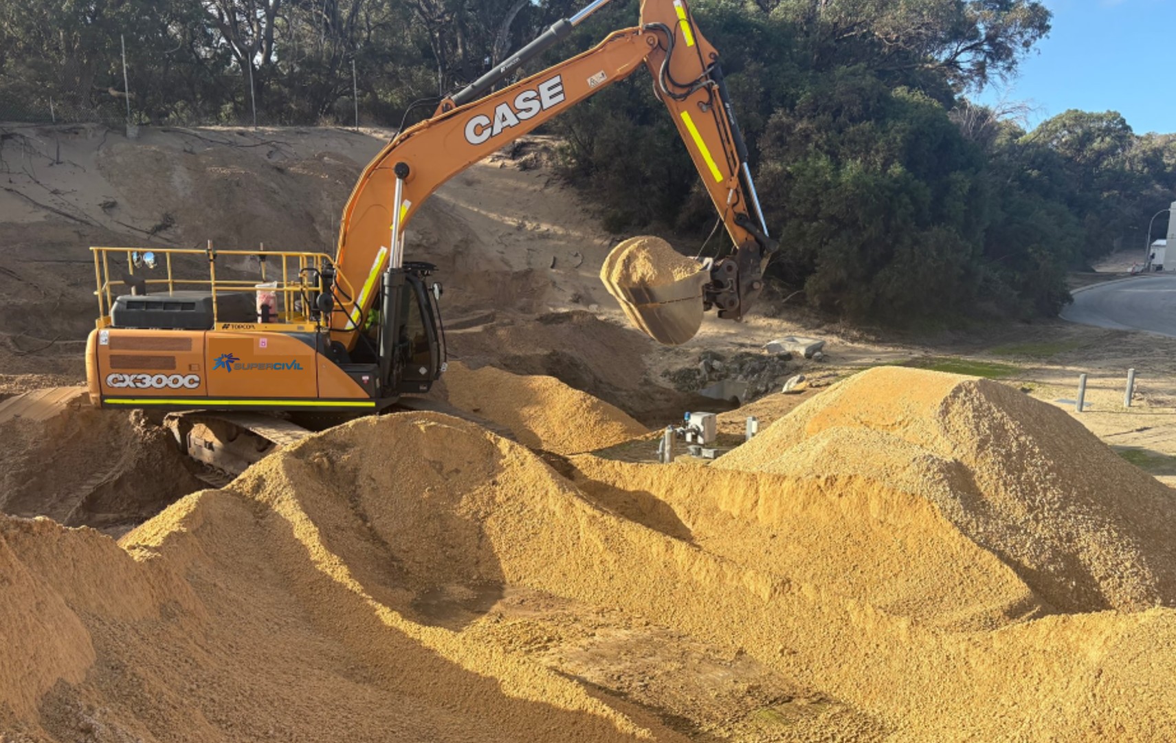YongaCivil-branded CASE CX300C tracked excavator moving sandy fill material with large mounds on a Western Australian earthworks site