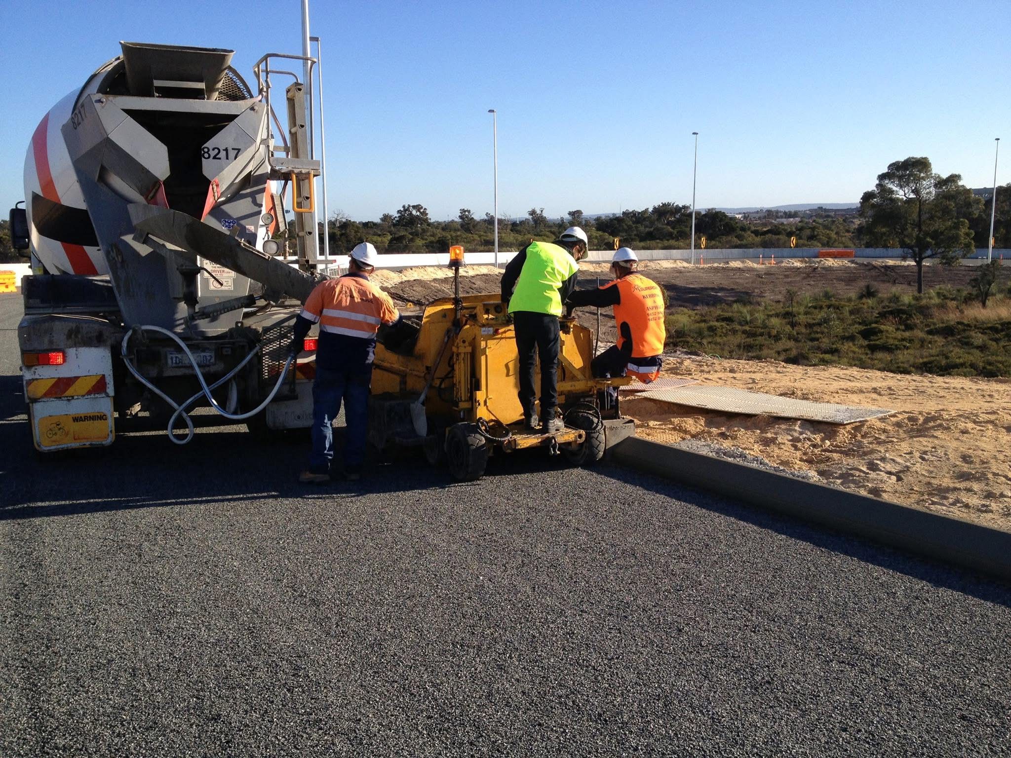 YongaCivil crew laying extruded concrete kerb with a kerbing machine on a Perth road project
