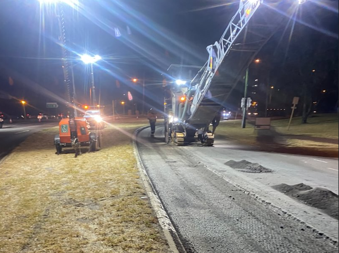 YongaCivil night-time road profiling operation under floodlights, with a cold-milling machine removing the road surface and hi-vis crew on a Western Australian road